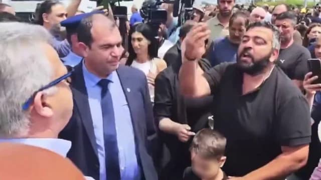 Cyprus: Distressed Farmer Hands Child to Justice Minister in Protest