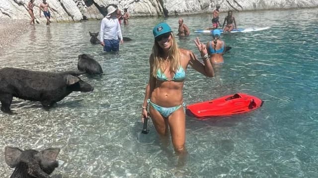 Marietta Chrousala swims with pigs in Atokos